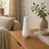 Stadler Form Tina witte aroma diffuser met geurbol-systeem en lichtgevende ring op houten nachtkastje