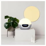 Lumie Bodyclock Shine 300 warmwit licht in minimalistische interieursetting met plant