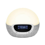 Frontaal beeld van grijze Lumie Bodyclock Shine 300 met warmwit licht en display