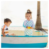 Kind draagt Snapper Rock UV-zwemkleding met stippen in boot op strand