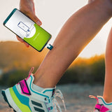 Heat-it device in gebruik op been tijdens sporten met app 'Treatment in Progress'