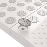 Witte modulaire drempelhulp met grijze antislipdoppen bevestigd