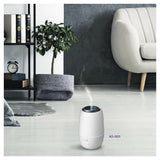witte aroma diffuser Clean Air Optima AD-303 in woonkamer met boekenplank en plant