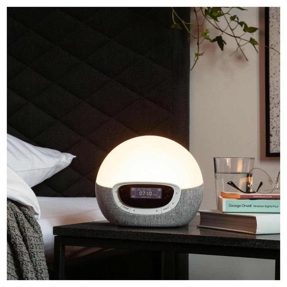 Lumie Bodyclock Shine 300 helderwit licht op nachtkastje bij boeken en glas water