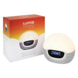 Lumie Bodyclock Shine 300 wake-up light naast oranje verpakking met FM-radio