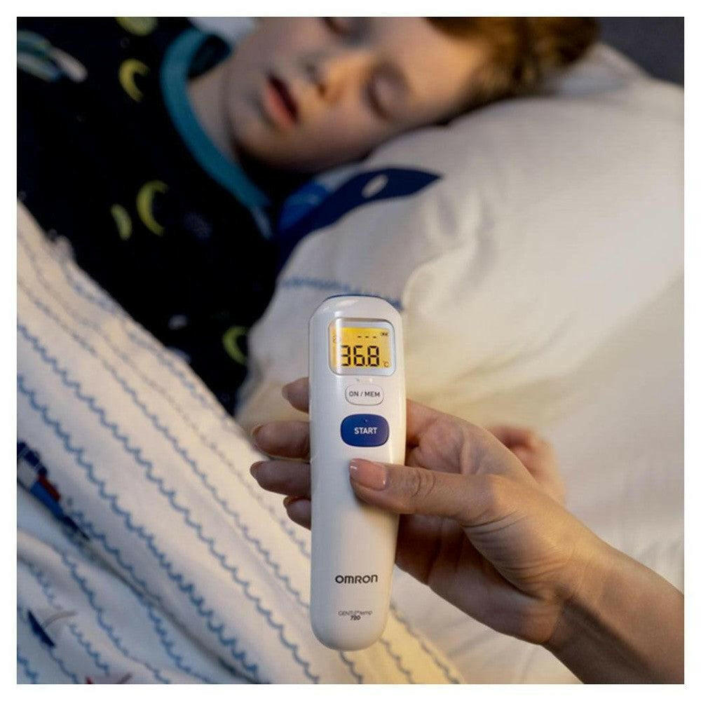 Hand houdt Omron Gentle Temp MC720 voorhoofdthermometer met meetresultaat